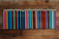 Colorful pencils arranged in a line on a wooden surface