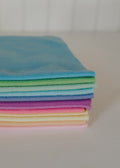 Stack of colorful folded felt on a light surface