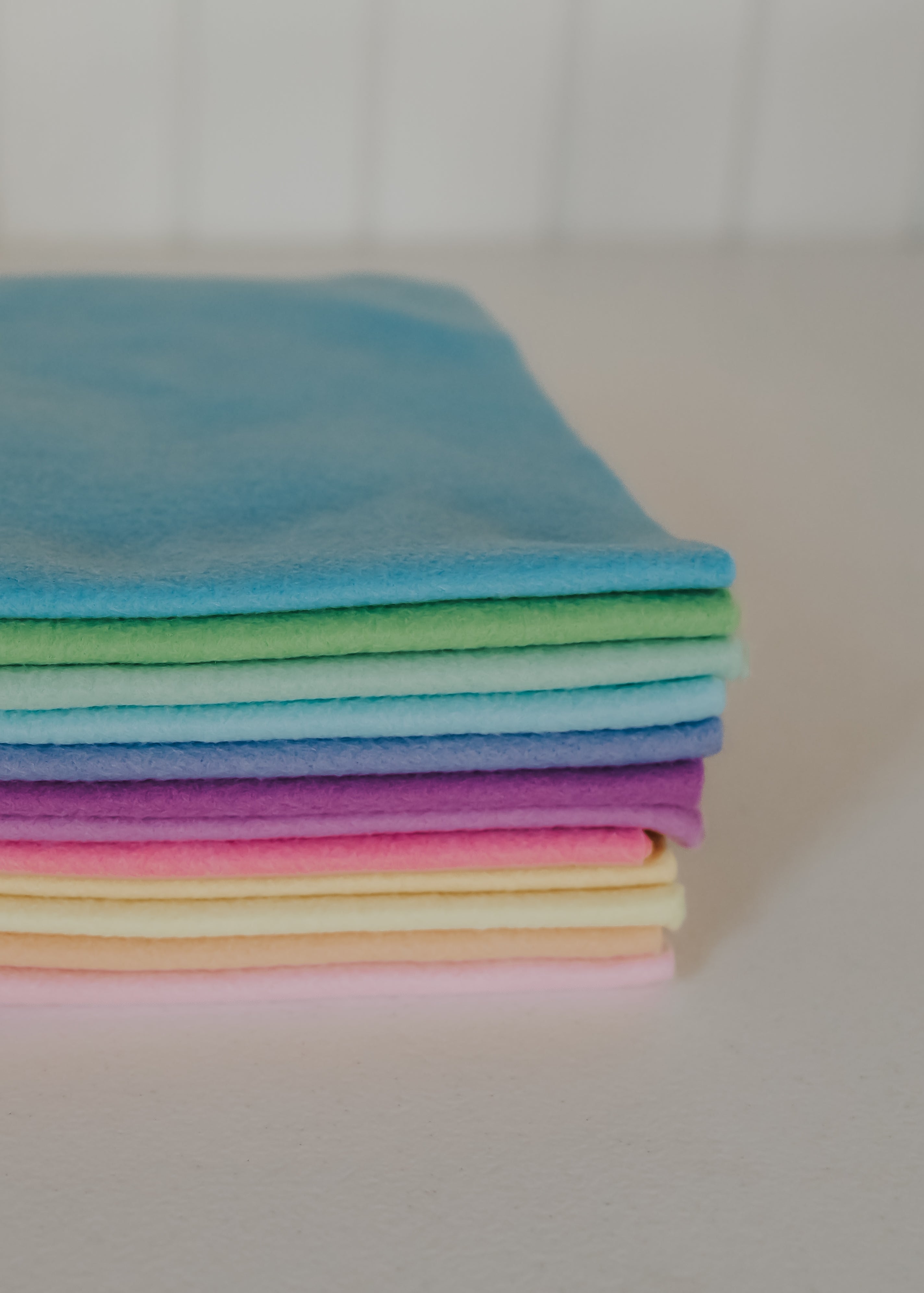Stack of colorful folded felt on a light surface
